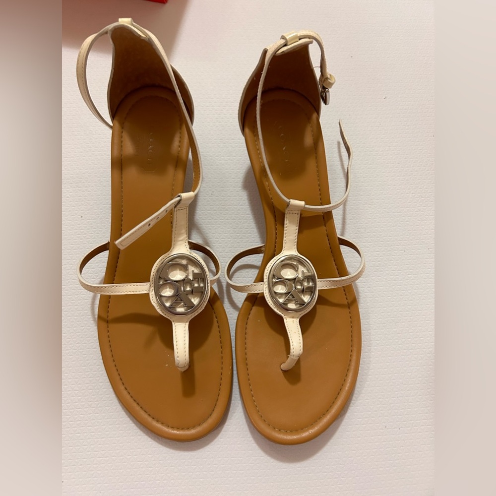 Coach Women's White Strappy Sandal with Gold Logo Medallion